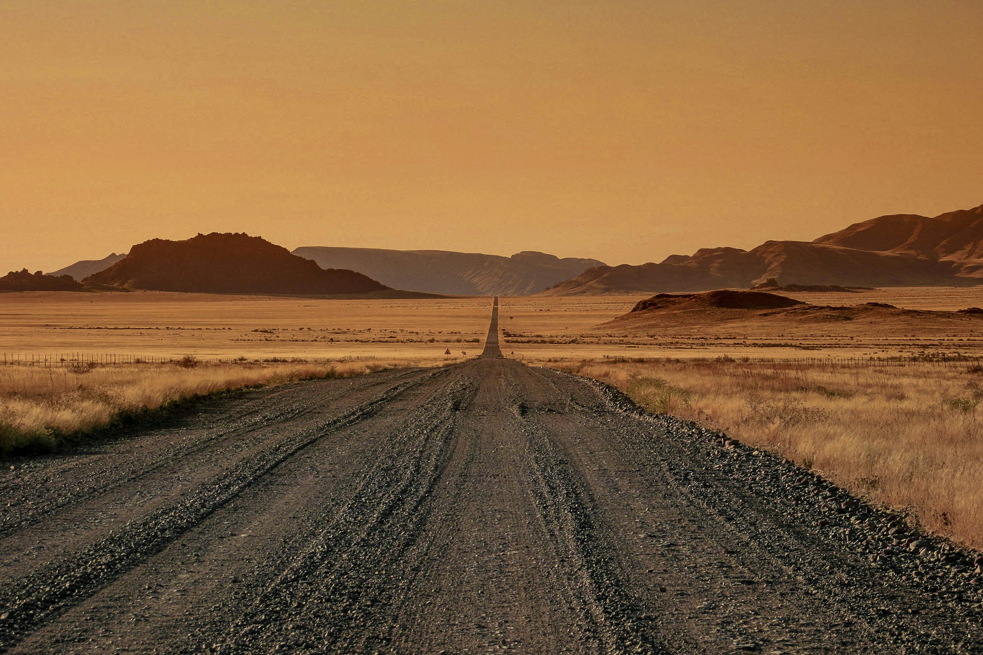 Open road through Namibia at golden hour